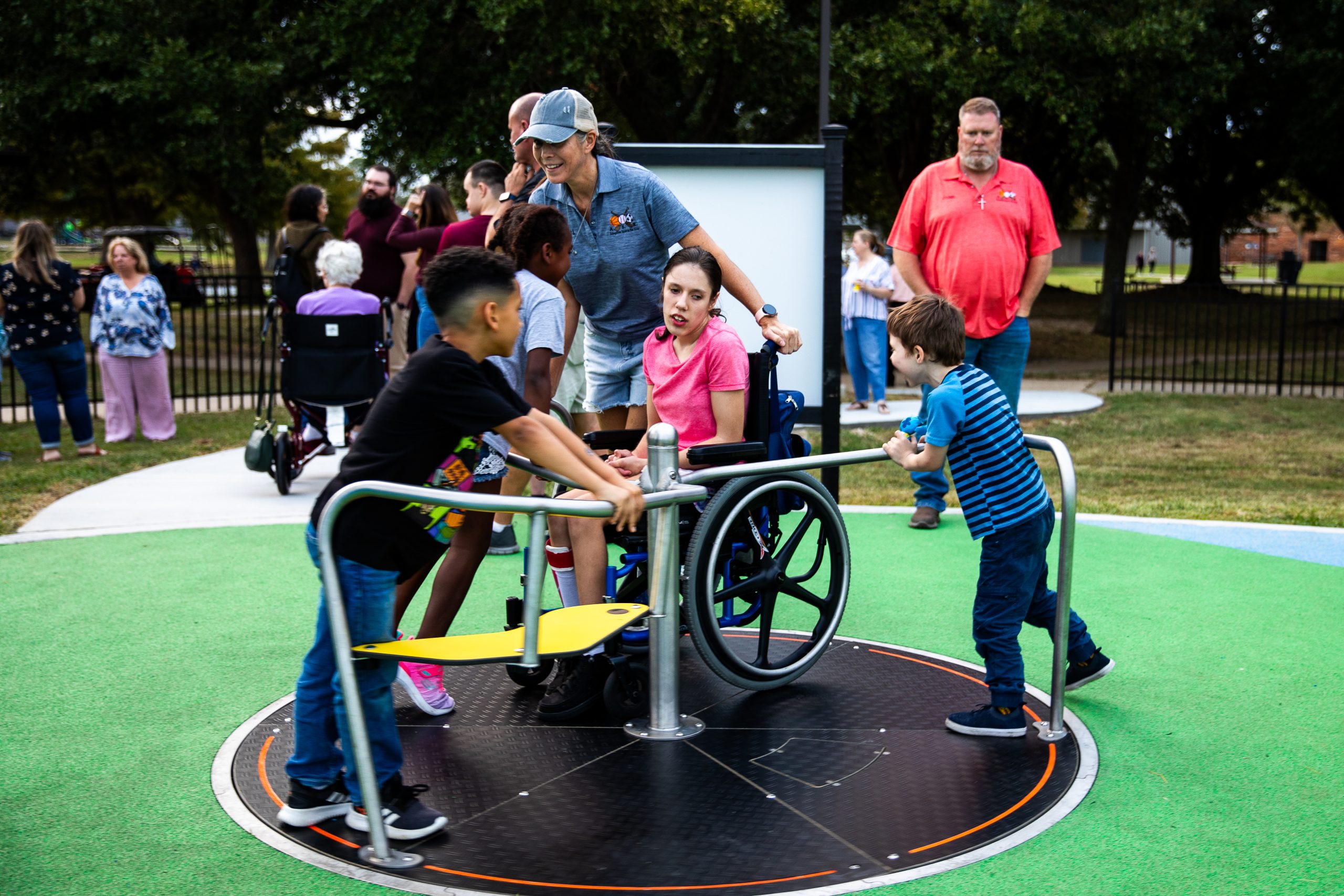 Children of all abilities enjoying the Inclusive Orbit commercial playground spinner.