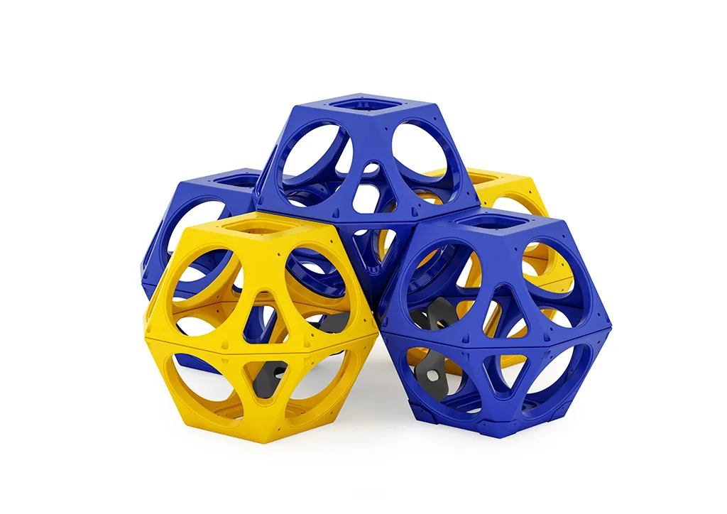 A vibrant ruby qube climbing playground equipment structure in a park setting, showcasing its modular geometric design and available color options.