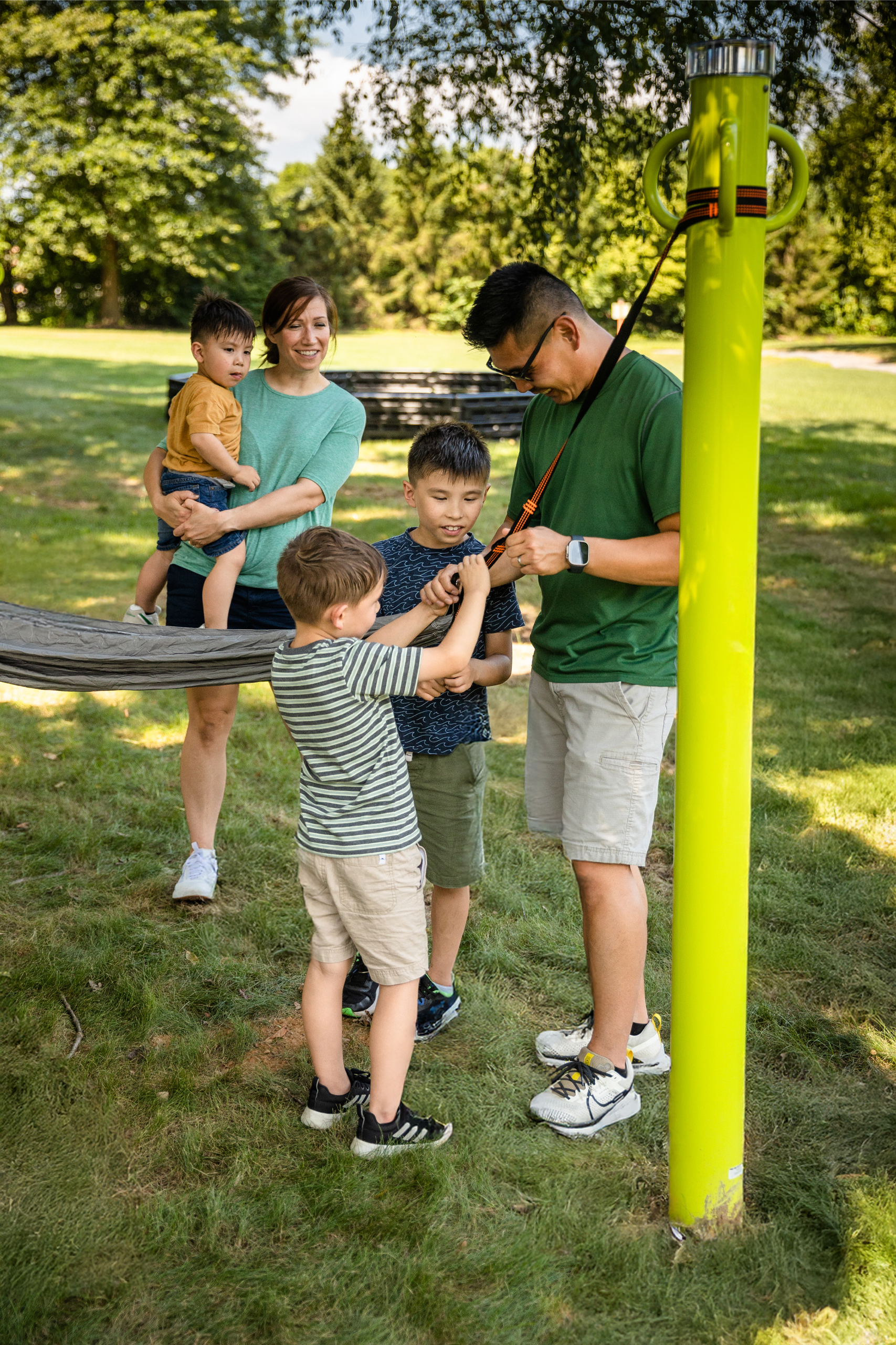 A modern hammocking post with PlaySoleil site in an outdoor park setting, designed for public use.